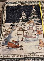 Full view of tapestry throw showing snowman scene and fringe