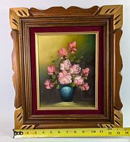 Front view of framed rose oil painting with ruler for scale
