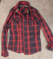 Front view of red and navy plaid long sleeve Arc'teryx shirt
