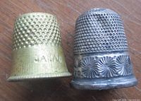 Both thimbles side by side showing materials and sizes