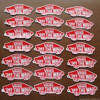 Full group of 21 red and white Vans Off The Wall decals displayed on tabletop