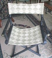 Front view of chair showing canvas seat/back and faux bamboo frame