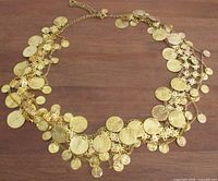 Full view of gold-tone coin belt laid flat
