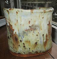 front view of glazed stoneware vessel showing color and texture