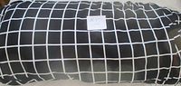 Full roll of black fabric with white grid pattern