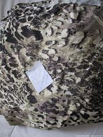 Folded bundle of animal print stretch fabric