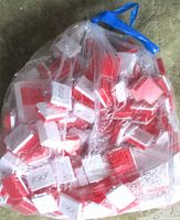 Full bag of assorted red and white plastic hinged boxes