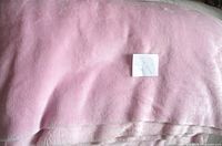Folded pink plush velour fabric bulk view