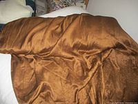 Full view of brown fabric draped to show sheen and texture