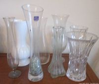 Group of eight vases showing variety of materials and shapes