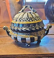 Front view of lidded tureen showing pattern, handles and finial