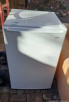 Front view of closed white Kenmore compact refrigerator
