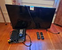 LG 32-inch TV with Magnavox DVD player, two remotes and cables