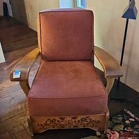 Front view showing painted floral apron and cushions