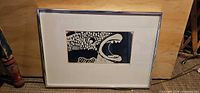 Framed linocut print showing full artwork and frame