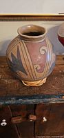 Round ceramic vase with geometric motifs on stand