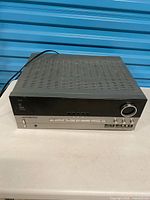 Front and top view of Harman Kardon AVR 330 receiver showing overall condition and attached power cord