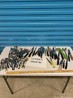 Full lot spread on table showing variety of flatware, knives and utensils