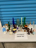 Full table view showing entire assortment of glass, ceramic and wood décor pieces