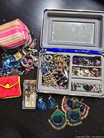 Entire lot showing jewelry case, pouches, loose earrings and accessories