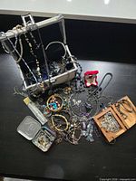 Overall view of jewelry pieces spread out with silver-tone chest