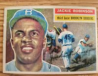 Front of 1956 Topps Jackie Robinson card showing portrait, action image and facsimile signature