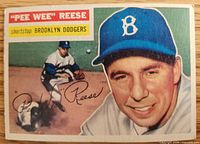 Front of 1956 Topps Pee Wee Reese card showing portrait, action scene, player name, team and position