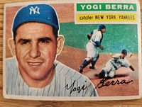 Front of 1956 Topps Yogi Berra card showing portrait, action scene and facsimile signature