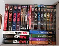 Box view showing multiple DVD box sets with visible titles such as Kavanagh QC, Cracker, Edge of Darkness, Inspector Morse, Mad Men