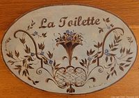 Front view of oval plaque showing full design and text