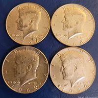 Obverse view of four Kennedy half dollars dated 1967, 1968, 1969, 1969
