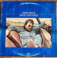 Front jacket of John Prine "Sweet Revenge" album showing title and artist