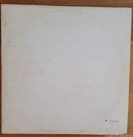 Front of embossed white gatefold jacket showing serial number 1033354