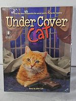 Front of sealed BePuzzled Under Cover Cat puzzle box