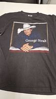 Front view of George Strait T-shirt with portrait graphic