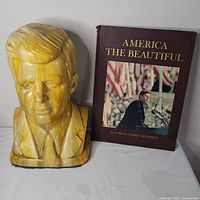 Bust front next to book front cover