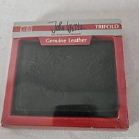 Front of boxed John Weitz trifold wallet showing brand, genuine leather label, and black wallet inside