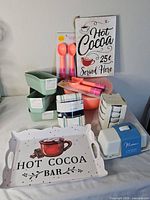 Group shot of all kitchen items including tray, sign, bowls, loaf pans, mixing bowl, spoons, towels, butter dish