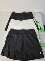 Three skorts laid flat showing two black and one white