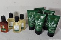 Full lot view showing four green tubes, three clear bottles, one brown bottle