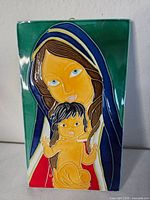 Front view showing Madonna and Child relief and glaze colours