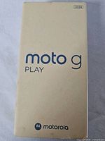 Front of beige retail box labeled moto g PLAY 2024