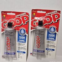 Front view of two sealed Amazing GOOP Marine adhesive tubes in blister packs