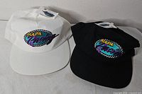 Both hats front view showing colors and logos