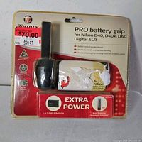 Front of sealed package showing Targus Pro battery grip and Extra Power branding