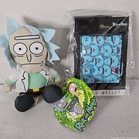 Plush Rick Sanchez doll, bifold wallet in packaging, and character tag