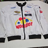 Front view of white racing jacket with logos and black trim
