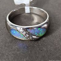 Top view of ring showing opal inlays and accent stones
