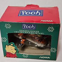 Front of Noma Pooh box showing Tigger stocking hanger through window