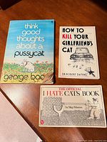 All three humour cat books laid out